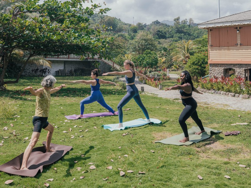 Active yoga outdoors with instructor
